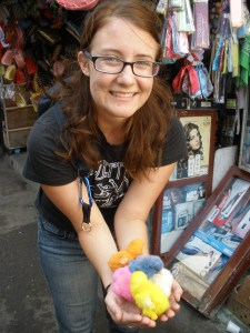 A poor woman was selling colored chicks for 1DH each. That's her living.